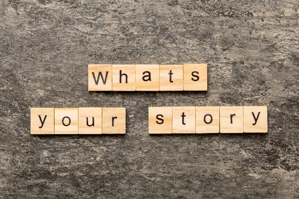 What\'s your story word written on wood block. What\'s your story text on cement table for your desing, Top view concept.