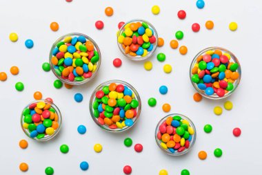 farklı renkte yuvarlak şekerler ve kavanozlar. Fotokopi alanı olan büyük çeşitlilikteki şeker ve şekerlerin üst görünümü.