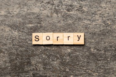 sorry word written on wood block. sorry text on table, concept. clipart