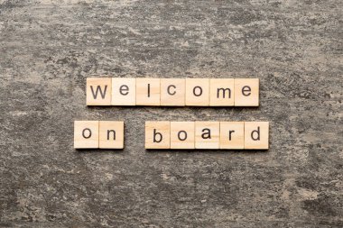 welcome on board word written on wood block. welcome on board text on table, concept.
