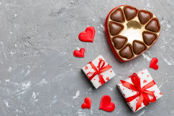 Delicious chocolate pralines in box for Valentine\'s Day. Heart shaped with gift box of chocolates top view with copy space.