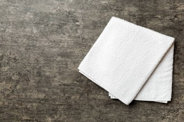 Renkli arkaplanda kopyalama alanı olan beyaz havluların üst görünümü.