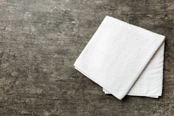 Renkli arkaplanda kopyalama alanı olan beyaz havluların üst görünümü.