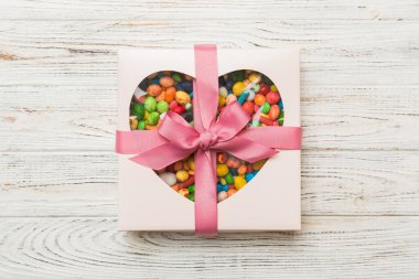 Box with sweet chocolate candies on color background, Various candy sweets. Valentines day gift box. Top view flat lay with copy space.