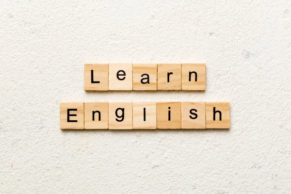 learn english word written on wood block. learn english text on table, concept.