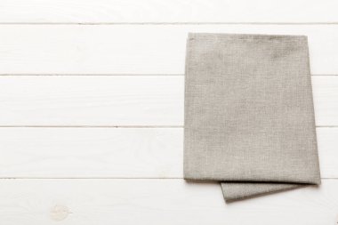 top view with gray kitchen napkin isolated on table background. Folded cloth for mockup with copy space, Flat lay. Minimal style.