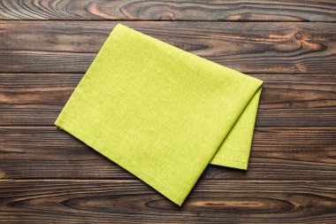top view with green kitchen napkin isolated on table background. Folded cloth for mockup with copy space, Flat lay. Minimal style.