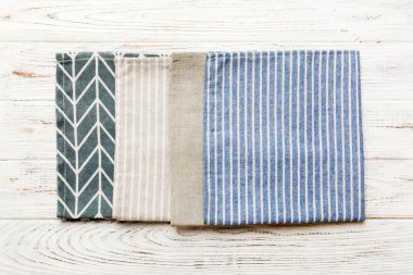 top view with blue kitchen napkin isolated on table background. Folded cloth for mockup with copy space, Flat lay. Minimal style.