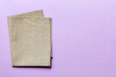 top view with gray kitchen napkin isolated on table background. Folded cloth for mockup with copy space, Flat lay. Minimal style.