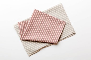 top view with red empty kitchen napkin isolated on table background. Folded cloth for mockup with copy space, Flat lay. Minimal style.