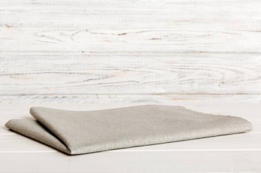 top view with gray kitchen napkin isolated on table background. Folded cloth for mockup with copy space, Flat lay. Minimal style.