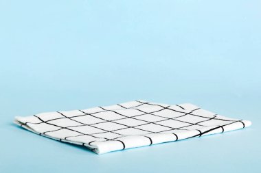 top view with white empty kitchen napkin isolated on table background. Folded cloth for mockup with copy space, Flat lay. Minimal style.