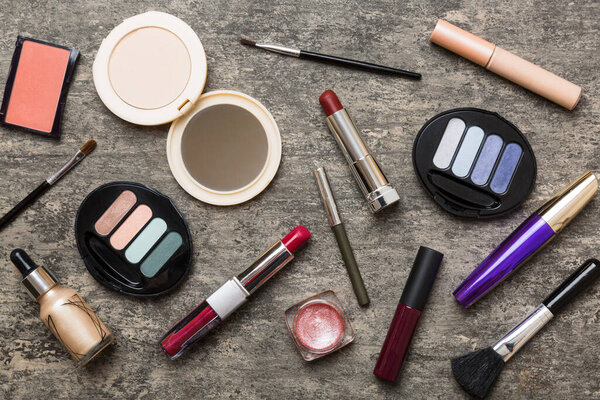 Professional makeup tools. Top view. Flat lay. Beauty, decorative cosmetics. Makeup brushes set and color eyeshadow palette on table background. Minimalistic style.