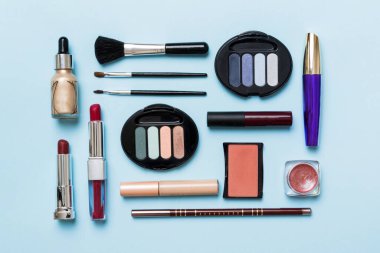 top view photo of valentine day decor female hands holding letter with envelope, small gift box and heart decoration on isolated pastel colored background with empty space.