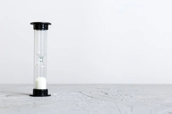 hourglass on the table, sand clock as time passing concept for business deadline, copy space.