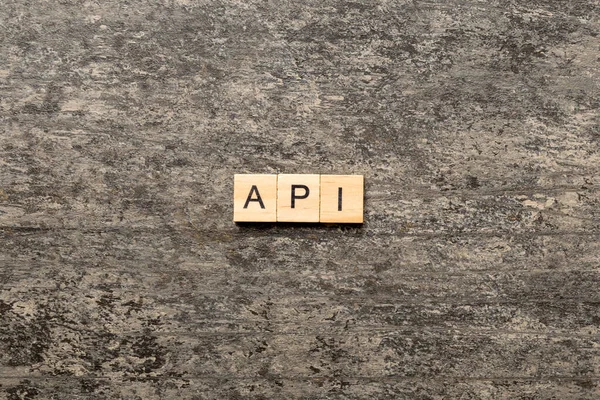 API word written on wood block. application program interface text on table, concept.