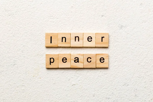 inner peace word written on wood block. inner peace text on table, concept.