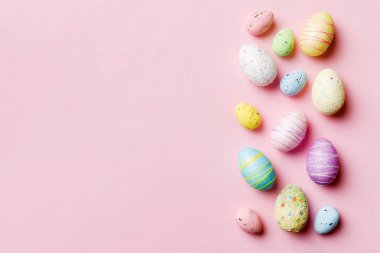 Happy Easter concept. Preparation for holiday. Easter eggs on colored background. flat lay top view copy space banner.