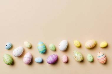 Happy Easter concept. Preparation for holiday. Easter eggs on colored background. flat lay top view copy space banner.