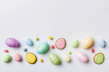 Happy Easter concept. Preparation for holiday. Easter eggs on colored background. flat lay top view copy space banner.