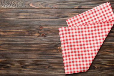 top view with red empty kitchen napkin isolated on table background. Folded cloth for mockup with copy space, Flat lay. Minimal style.