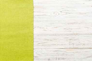 top view with green kitchen napkin isolated on table background. Folded cloth for mockup with copy space, Flat lay. Minimal style.