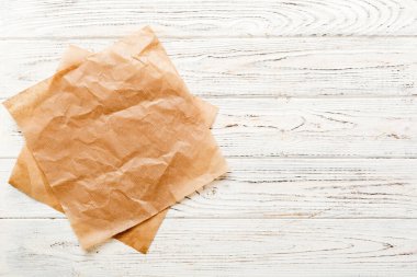 top view with baking parchment empty on table background. Folded cloth for mockup with copy space, Flat lay. Minimal style.