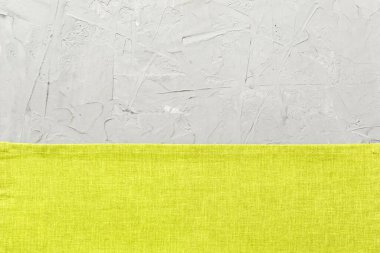 top view with green kitchen napkin isolated on table background. Folded cloth for mockup with copy space, Flat lay. Minimal style.