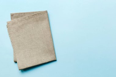 top view with gray kitchen napkin isolated on table background. Folded cloth for mockup with copy space, Flat lay. Minimal style.