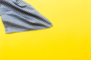 top view with blue kitchen napkin isolated on table background. Folded cloth for mockup with copy space, Flat lay. Minimal style.