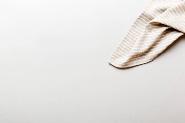 top view with gray kitchen napkin isolated on table background. Folded cloth for mockup with copy space, Flat lay. Minimal style.