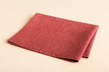 top view with red empty kitchen napkin isolated on table background. Folded cloth for mockup with copy space, Flat lay. Minimal style.