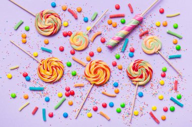 Lezzetli İştah açıcı Parti Aksesuarları Mutlu Yıllar Tatlı. Renkli arkaplanda farklı tipte şekerler, kopyalama alanı. Renkli doğum günü partisi geçmişi.