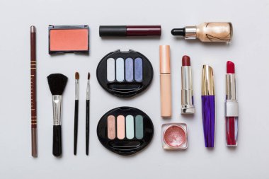 Professional makeup tools. Top view. Flat lay. Beauty, decorative cosmetics. Makeup brushes set and color eyeshadow palette on table background. Minimalistic style.