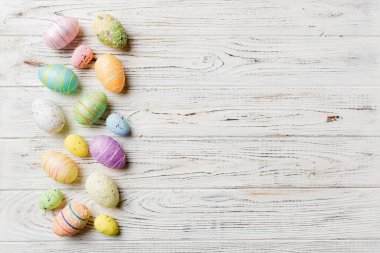 Happy Easter concept. Preparation for holiday. Easter eggs on colored background. flat lay top view copy space banner.