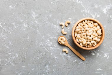 cashew nuts in wooden bowl on table background. top view. Space for text. Healthy food