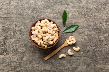 cashew nuts in wooden bowl on table background. top view. Space for text. Healthy food