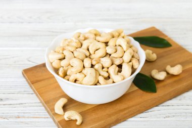 cashew nuts in wooden bowl on table background. top view. Space for text. Healthy food