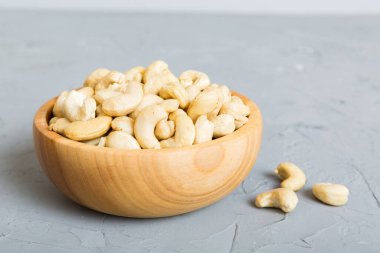cashew nuts in wooden bowl on table background. top view. Space for text. Healthy food