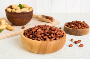 Fresh healthy peanuts in bowl on colored table background. Top view Healthy eating bertholletia concept. Super foods.