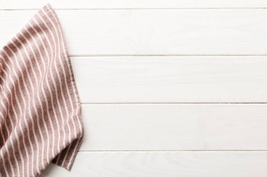 top view with red empty kitchen napkin isolated on table background. Folded cloth for mockup with copy space, Flat lay. Minimal style.