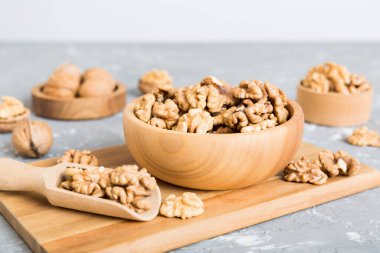 Fresh healthy walnuts in bowl on colored table background. Top view Healthy eating bertholletia concept. Super foods.