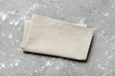 top view with gray kitchen napkin isolated on table background. Folded cloth for mockup with copy space, Flat lay. Minimal style.