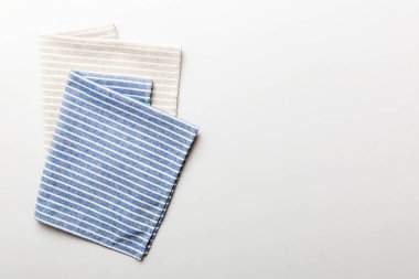top view with blue kitchen napkin isolated on table background. Folded cloth for mockup with copy space, Flat lay. Minimal style.