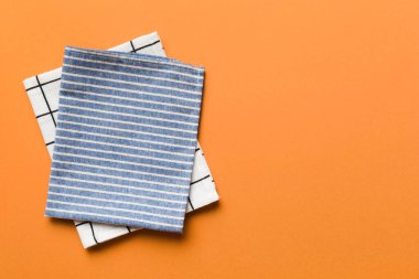 top view with blue kitchen napkin isolated on table background. Folded cloth for mockup with copy space, Flat lay. Minimal style.