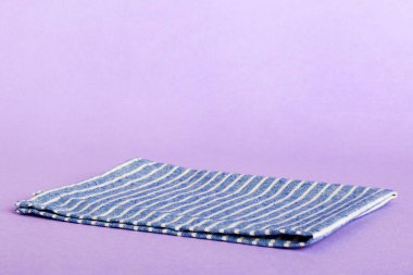 top view with blue kitchen napkin isolated on table background. Folded cloth for mockup with copy space, Flat lay. Minimal style.