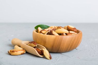 Fresh healthy Brazil nuts in bowl on colored table background. Top view Healthy eating bertholletia concept. Super foods.