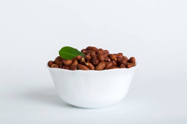 Fresh healthy peanuts in bowl on colored table background. Top view Healthy eating bertholletia concept. Super foods.