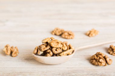 Fresh healthy walnuts in bowl on colored table background. Top view Healthy eating bertholletia concept. Super foods.
