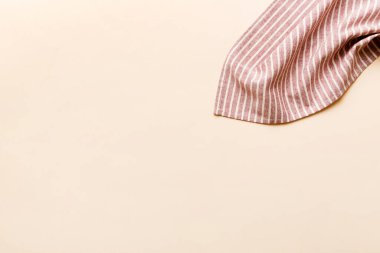 top view with red empty kitchen napkin isolated on table background. Folded cloth for mockup with copy space, Flat lay. Minimal style.